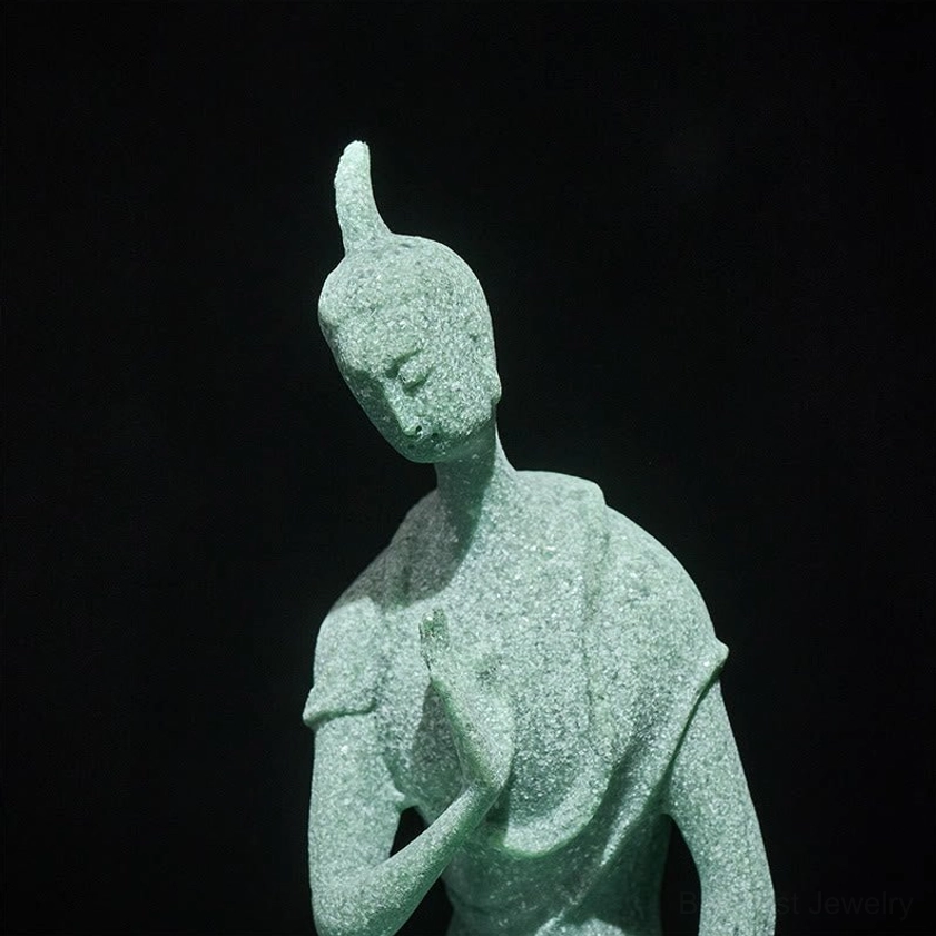 Close-up frontal view of Buddha statue face and hand gesture, serene expression and detailed craftsmanship, studio lighting