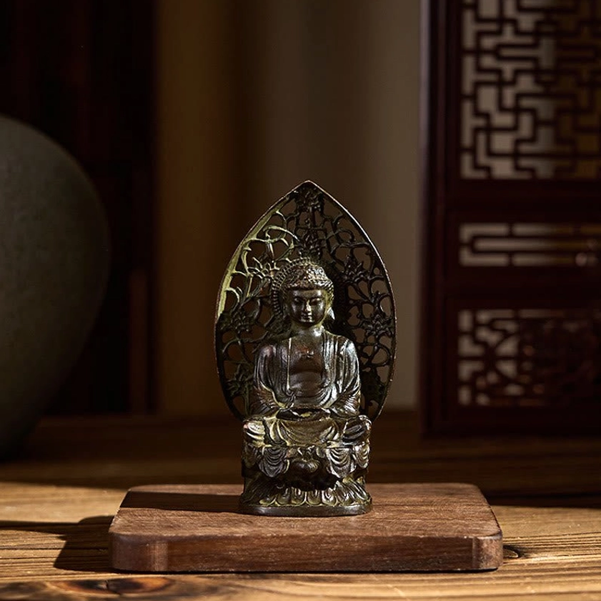 Compact Buddha statue on wooden base displaying antique bronze finish and meditation posture