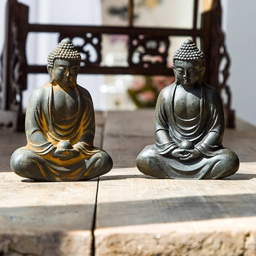 Meditating Buddha statue showing full cross-legged meditation pose with serene expression