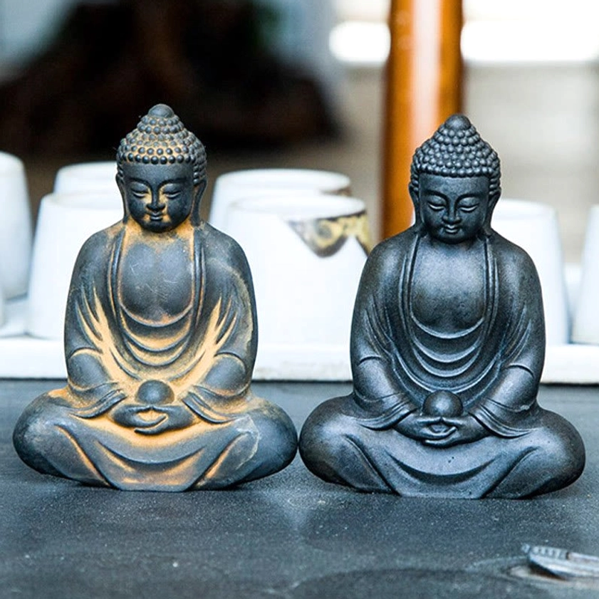 Meditating Buddha statue showing serene meditation pose with hands in dharma mudra position
