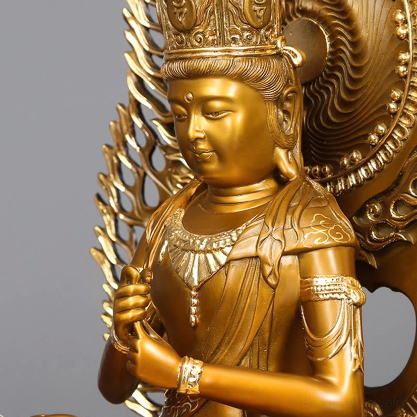 Close-up detail of Tathagata Buddha statue face and upper body showing serene facial expression and ornate crown carving