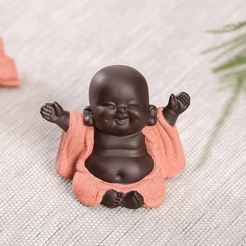 Happy Buddha figurine front straight view on linen background, full clear seated statue for feng shui and spiritual practice