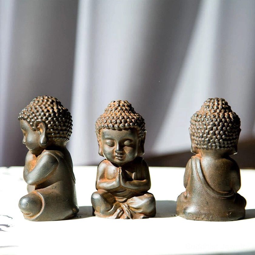 Mini Buddha statue set front view on white background - three meditative figurines different hand poses