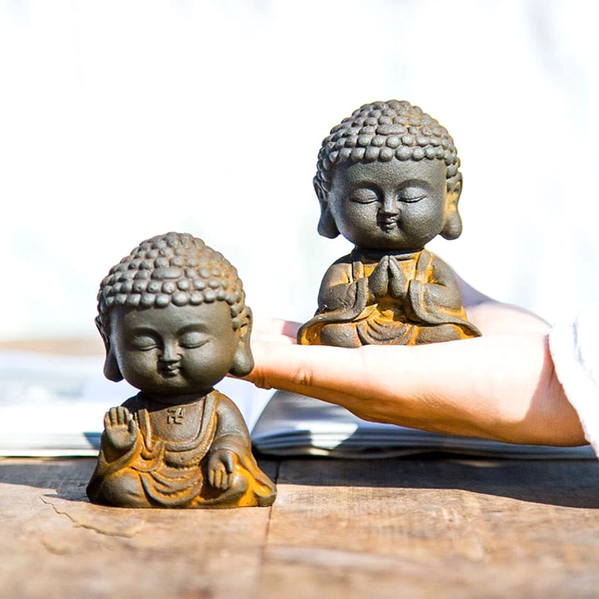 Side and close-up view of two handcrafted Buddha statues with different hand gestures and mudra positions