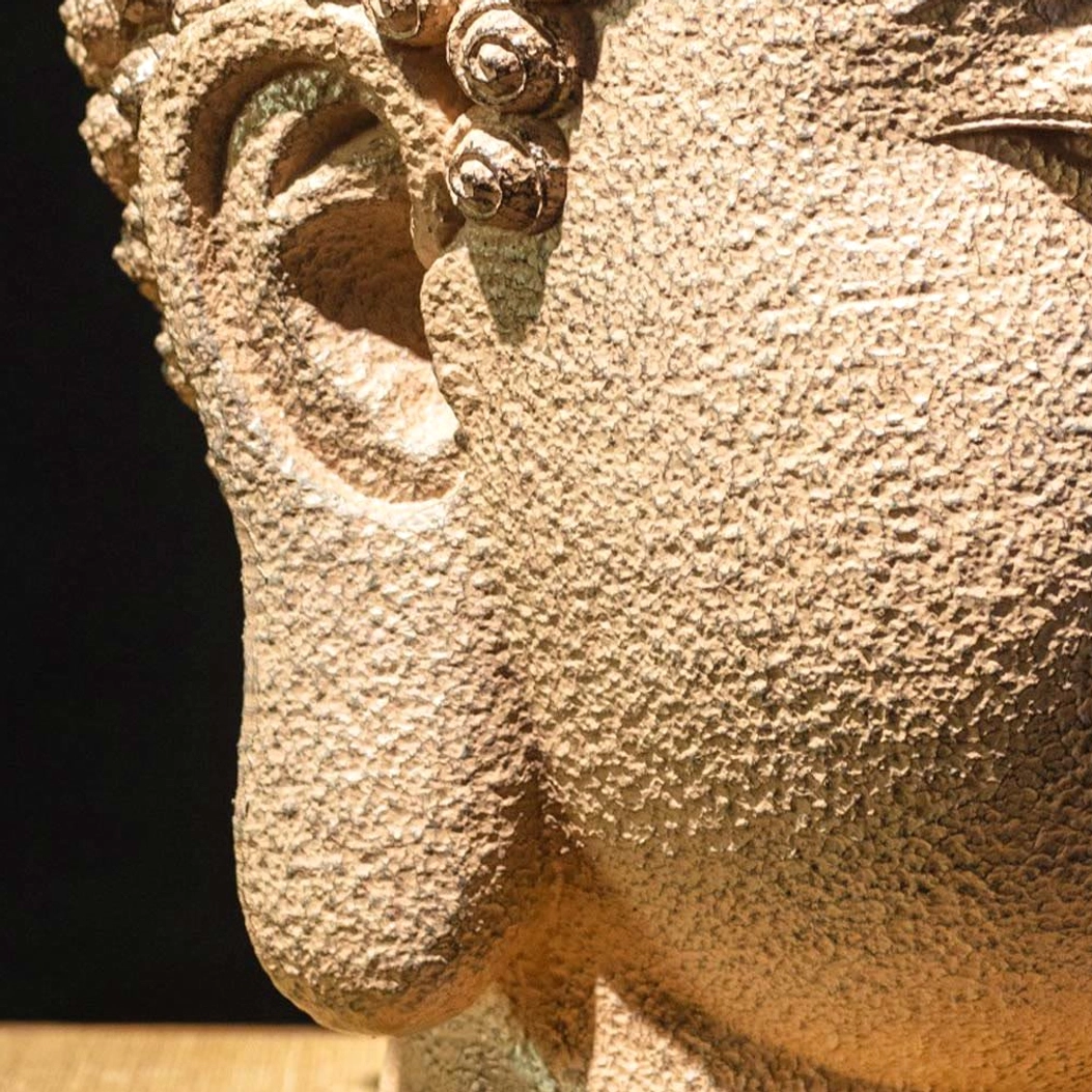 Meditating Buddha head statue textured resin surface showing natural handcrafted variations and matte finish