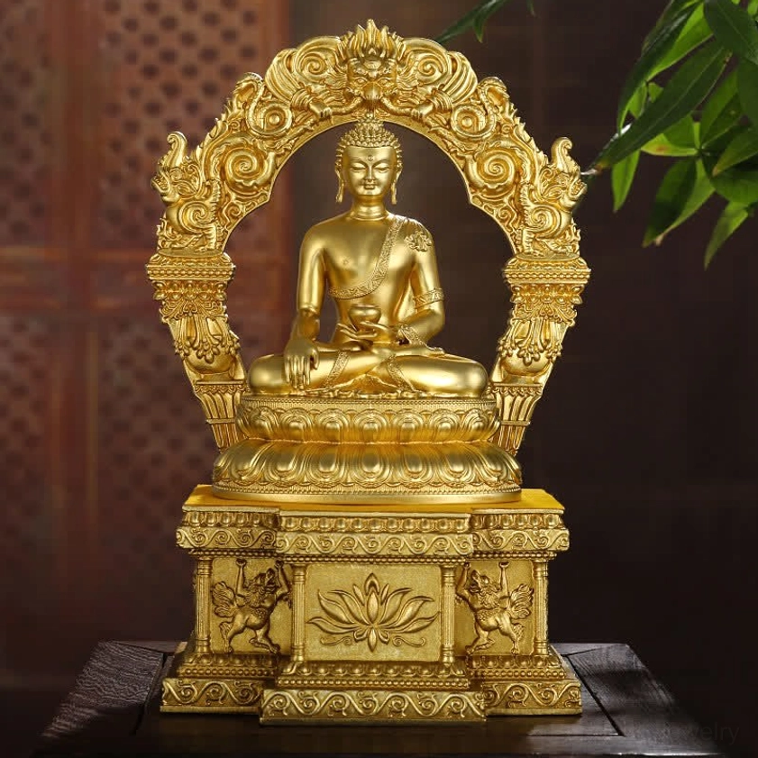 Hand-cast copper Buddha statue displayed on home tabletop with golden finish and natural backdrop