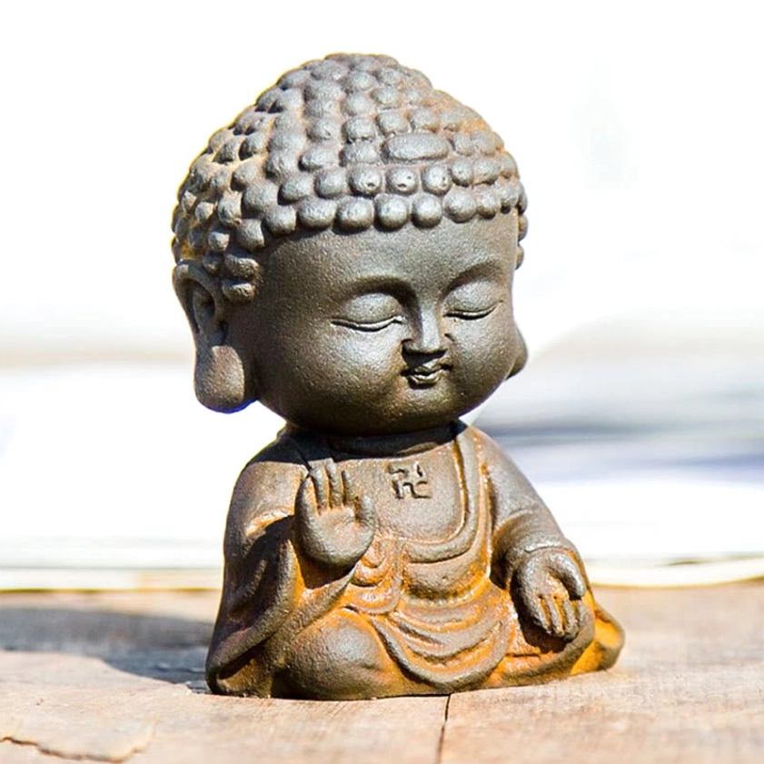 Buddha figurine detail showing iron powder material texture and natural weathered surface finish
