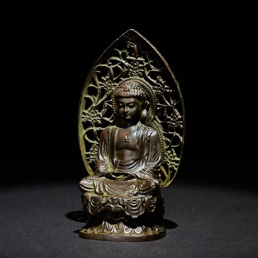 Tathagata Buddha statue left front angle with green patina bronze finish and ornamental backboard