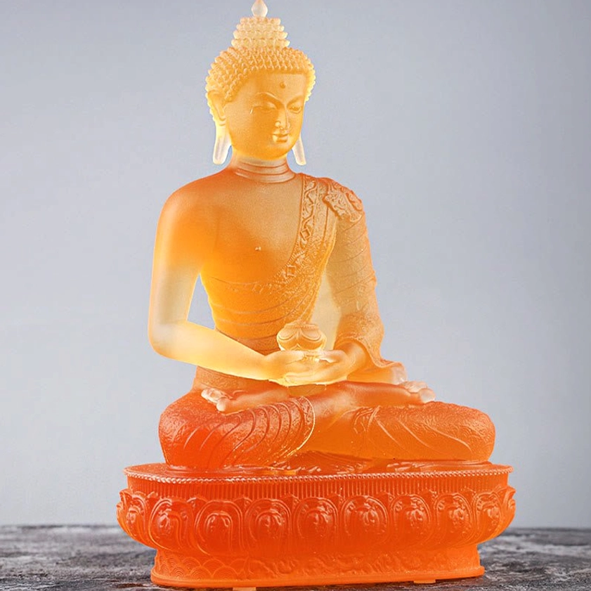 Handcrafted Liuli glass Buddha statue detail showing lotus base carving and meditation posture with spiritual symbolism