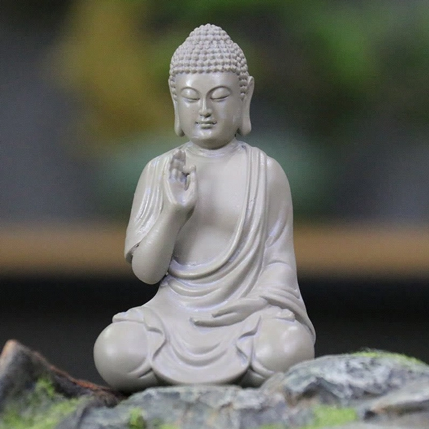 Seated Buddha statue with cross-legged meditation pose symbolizing enlightenment and spiritual balance in resin craft