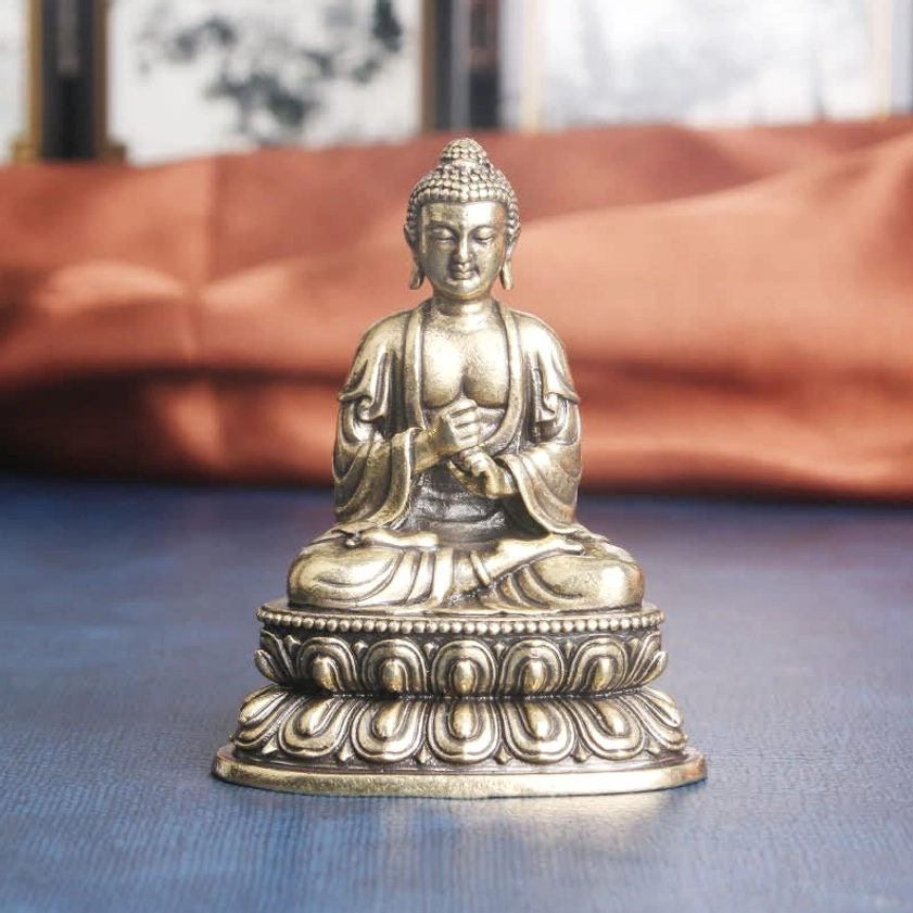 Handcrafted brass Buddha meditation statue front view, seated in lotus position with ornate carved base, antique copper finish