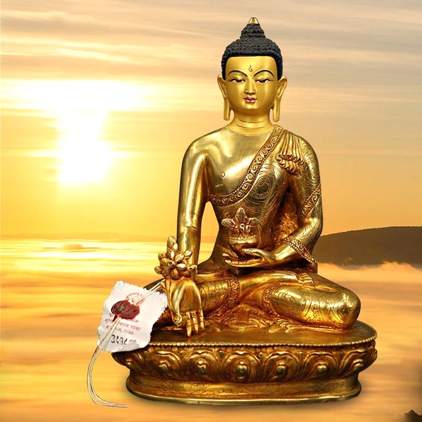 Golden Buddha meditation statue in cross-legged pose holding ritual bowl, sunset backdrop creating warm spiritual ambiance