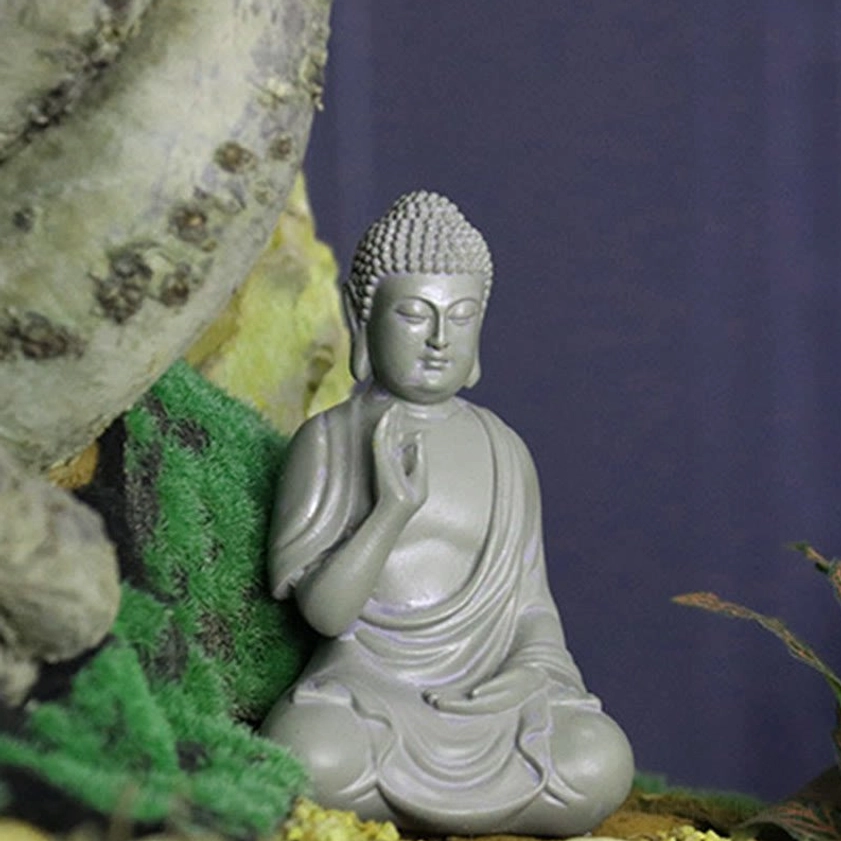 Small Buddha desk statue showing versatile home decoration placement on workspace shelf for calm and focus