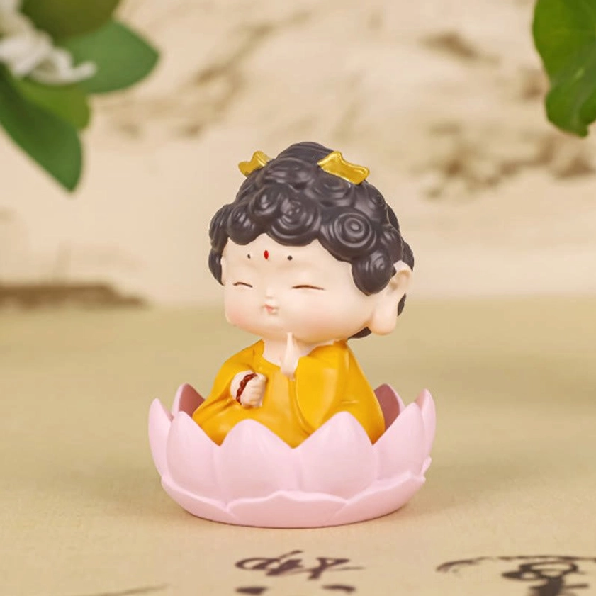 Front view of sitting Buddha resin statue in prayer hand gesture with pink lotus base and yellow robe