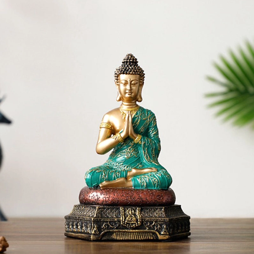 Buddha compassion figure with praying hands gesture in serene meditation posture on ornate base