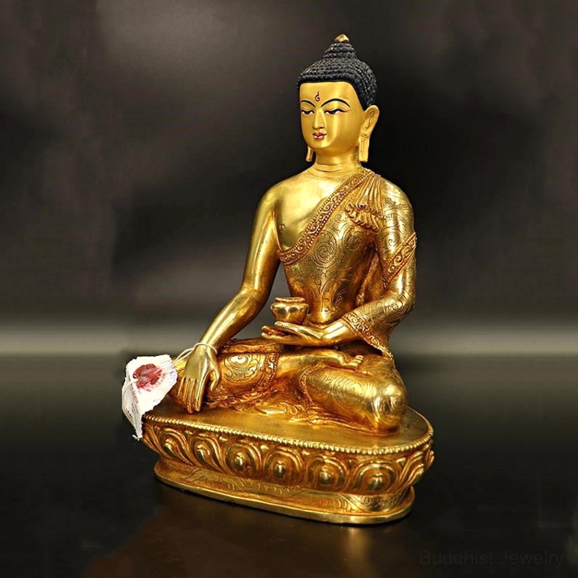 Three-quarter rear view of handcrafted Buddha statue showing intricately engraved robes and serene posture