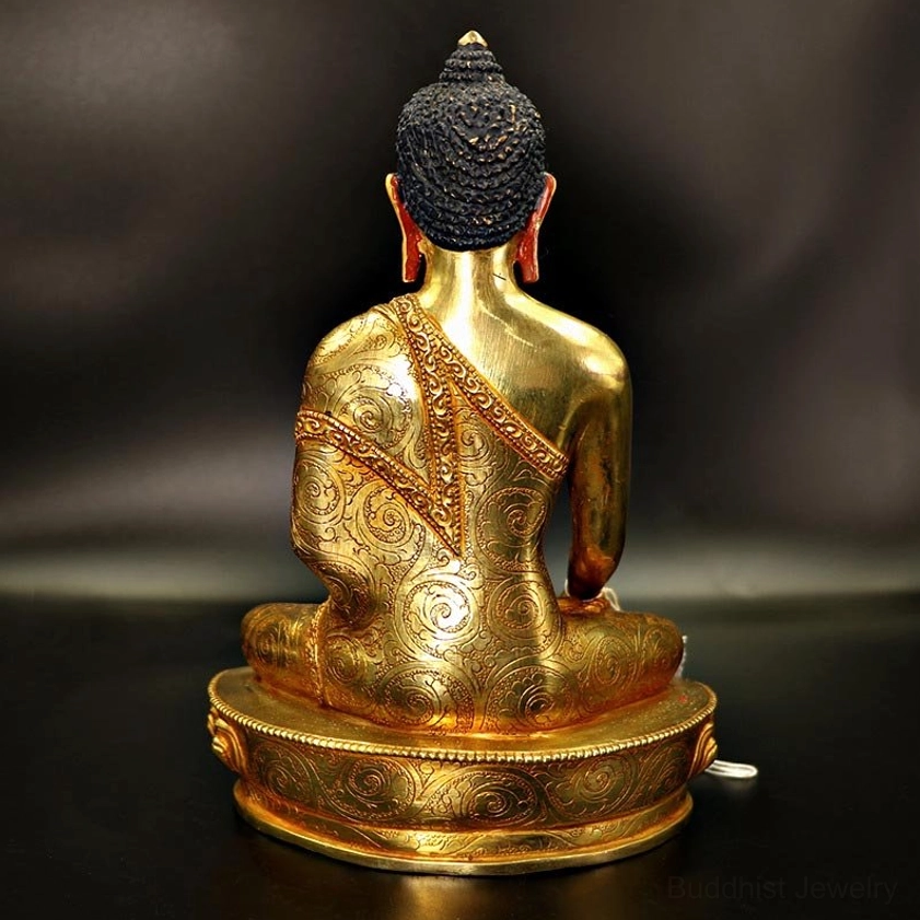 Rear full view of Buddha statue showcasing intricate hand-engraved robe details and polished golden metal surface