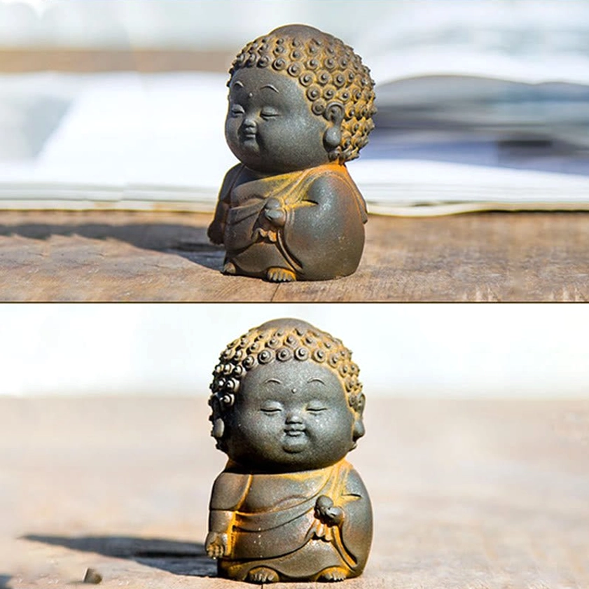 Close-up detail of Buddha figurine surface showing matte rustic patina and natural material texture