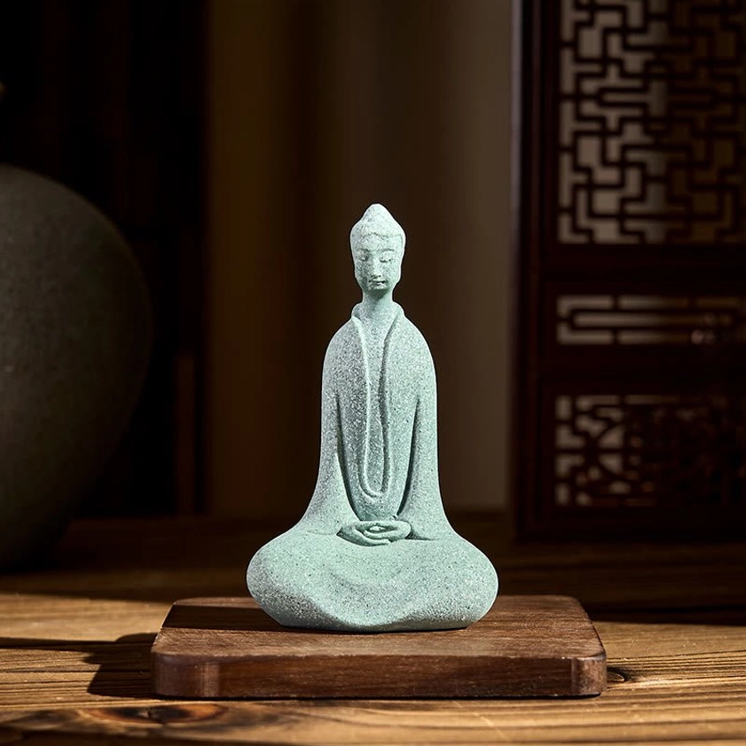 Buddha meditation statue displayed on traditional wooden lattice base showing craftsmanship and home decor styling