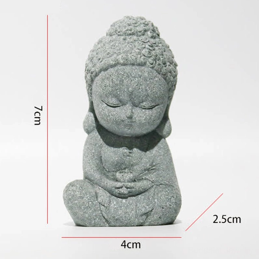 Seated mini Buddha statue with hands resting on abdomen, dark grey stone texture, meditative pose for spiritual home decor