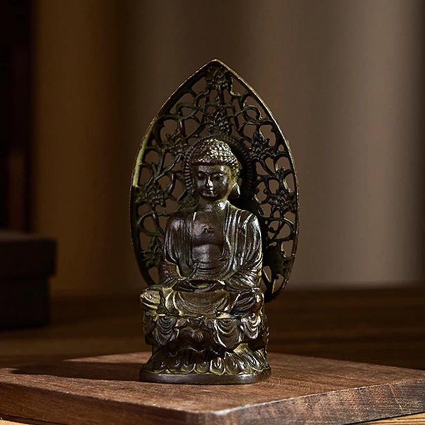 Buddha meditation statue side view highlighting carved features and lotus seat on wood background