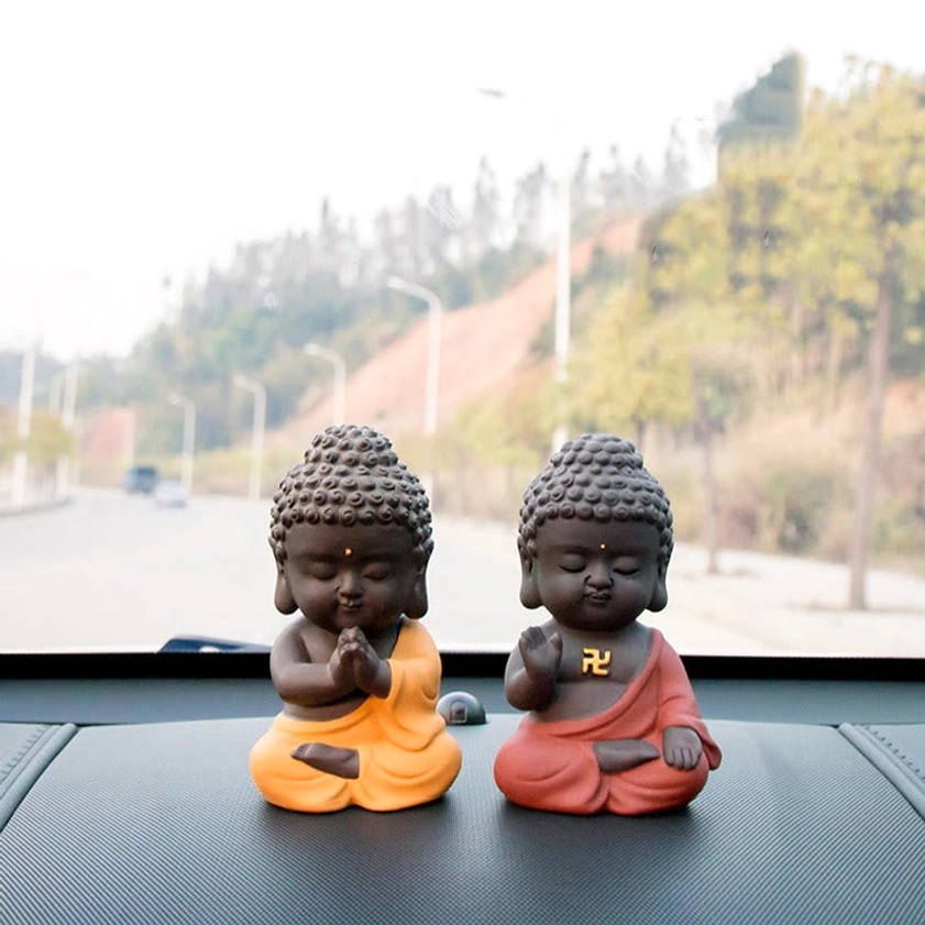 Purple clay Buddha statue side profile view, showcasing serene facial features and traditional spiritual design elements