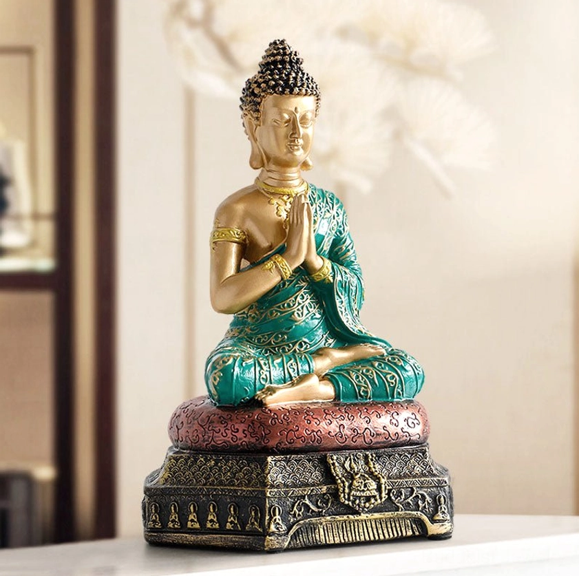 Buddhist resin statue side profile view showing carved robe details and decorative red cushion base