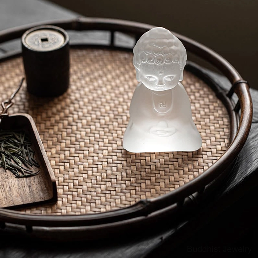 Buddhist desk decoration statue placed among tea ceremony accessories and bamboo tray