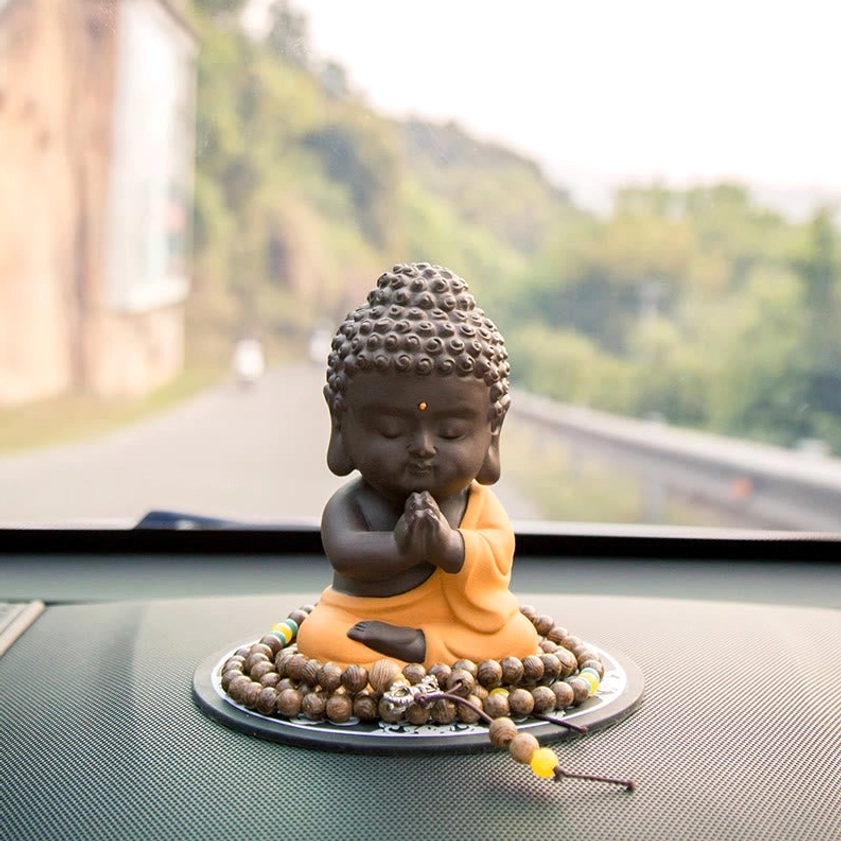 Collection view of Buddha statues in different color variants, showing red and yellow robe options in natural purple clay
