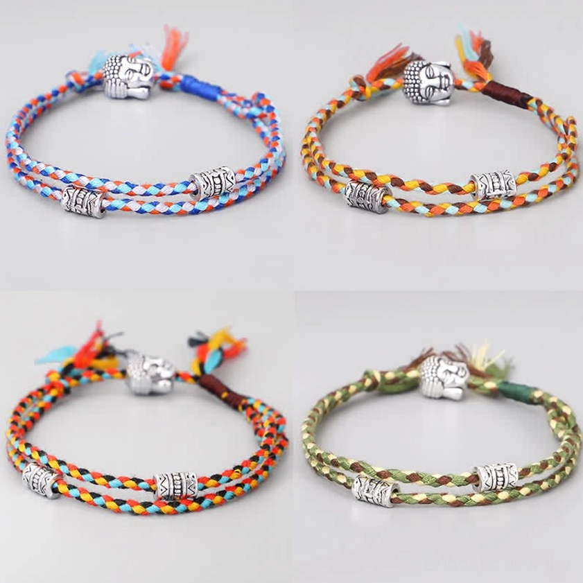 Four assorted Buddha head string bracelets in different colors arranged in grid, overhead view showing all variants