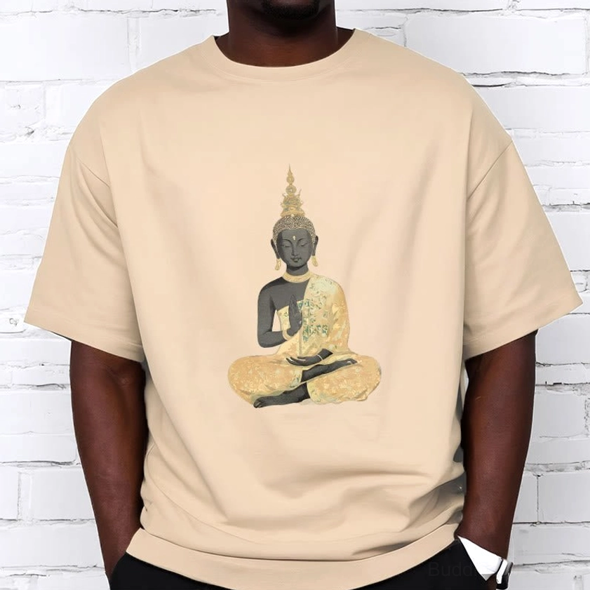 Male model wearing meditating Buddha cotton t-shirt with golden-black print on brick background