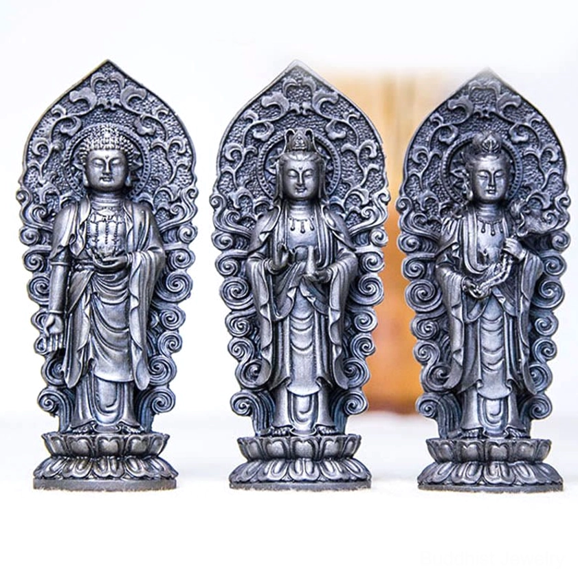 Handcrafted detail focus of Buddhist trinity statue showing individual facial features and robes carving of Amitabha, Guanyin and Mahasthamaprapta