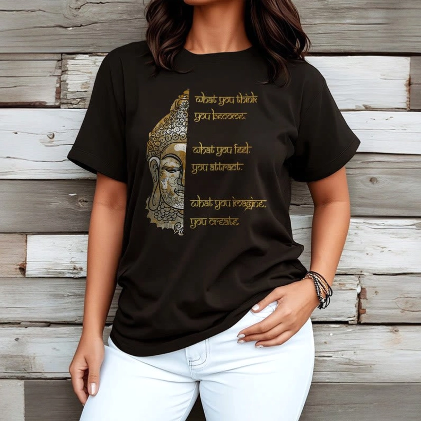 Woman wearing black Buddhist affirmation t-shirt with gold Buddha graphic and wooden panel background