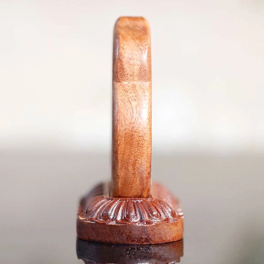 Hand-carved Buddha wood statue rear side view showing solid dark brown wood and ornate lotus base