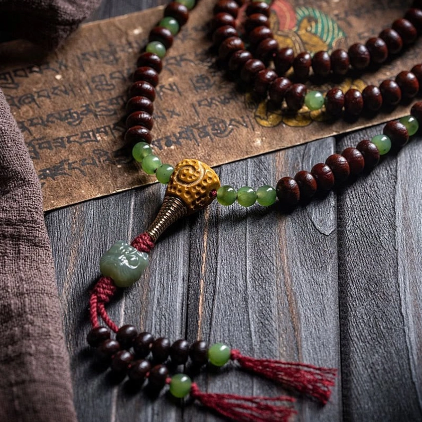 Buddhist 108 mala beads set with guru bead and red tassel showing complete strand assembly