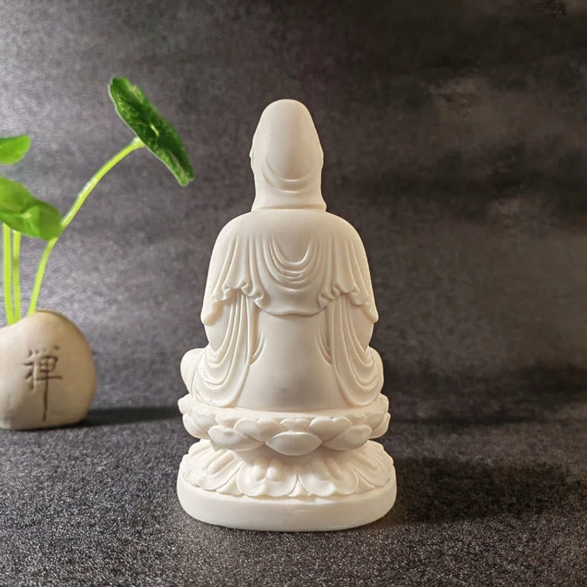 Buddhist altar decoration with multiple ivory fruit Buddha statues - spiritual workspace setup