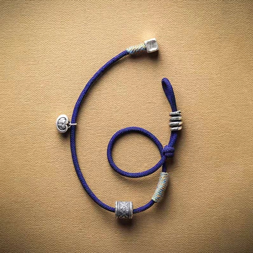 Buddhist amulet bracelet back view with spiral adjuster and silver decorative components