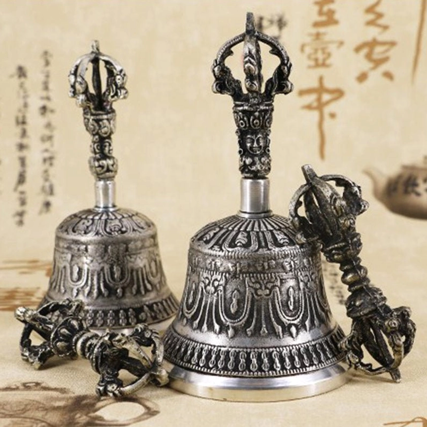 Authentic handmade Buddhist meditation bell and vajra dorje copper set overhead view with intricate religious carvings and traditional calligraphy