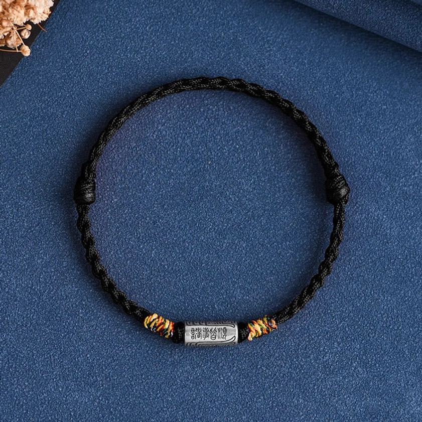 Buddhist string bracelet variant with black braided rope and sterling silver protection charm, front display view