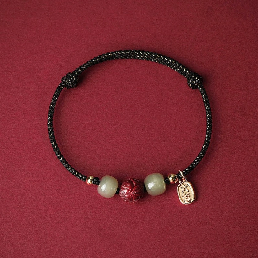 Black braided Buddhist protection bracelet with Hetian jade beads, cinnabar lotus pendant, gold accents, spiritual wellness and grounding energy