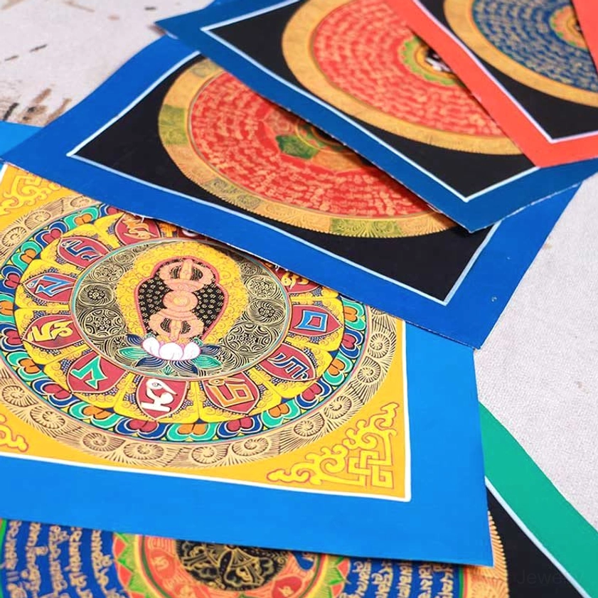 Tibetan Buddhist blessing thangka with central Buddha deity figure surrounded by traditional sacred scripture and layered decorative mats