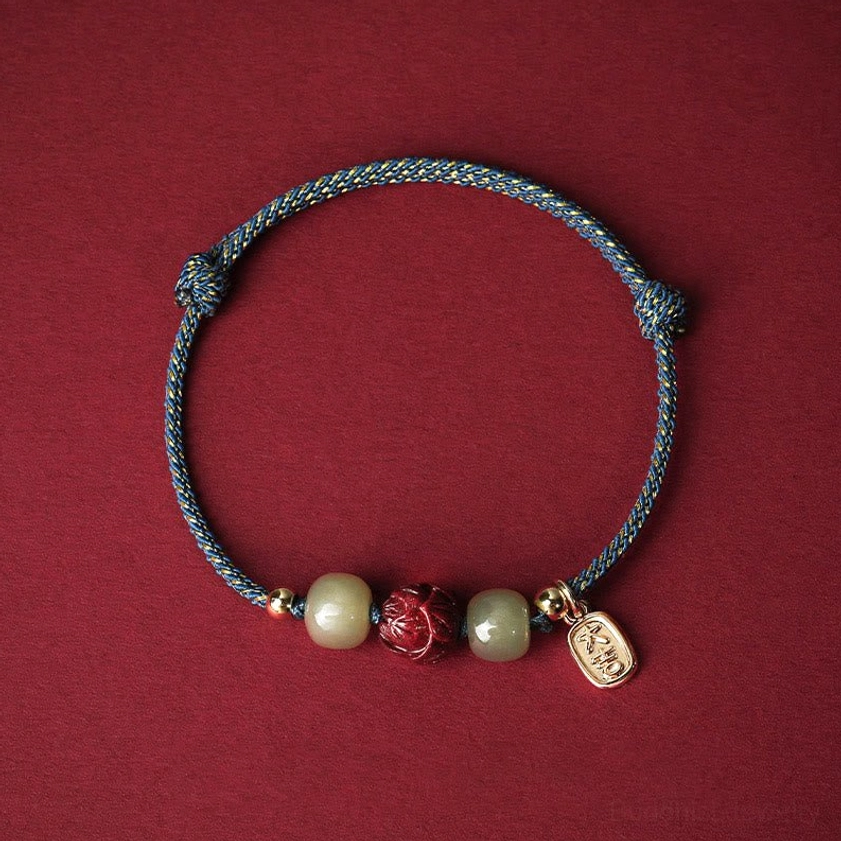 Blue-gray braided Buddhist luck bracelet with polished Hetian jade beads, hand-carved cinnabar lotus charm, 14K gold plating, calming spiritual energy