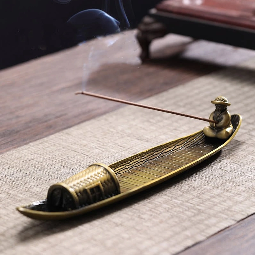 Buddhist meditation incense burner three-quarter view with burning incense and woven cabin decor