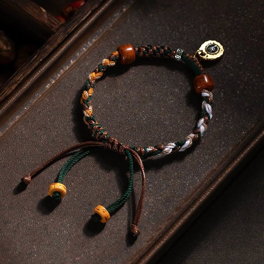 Authentic Buddhist string bracelet with braided mixed-color rope, brown bone beads, metal pendant, and loose adjustable drawstring