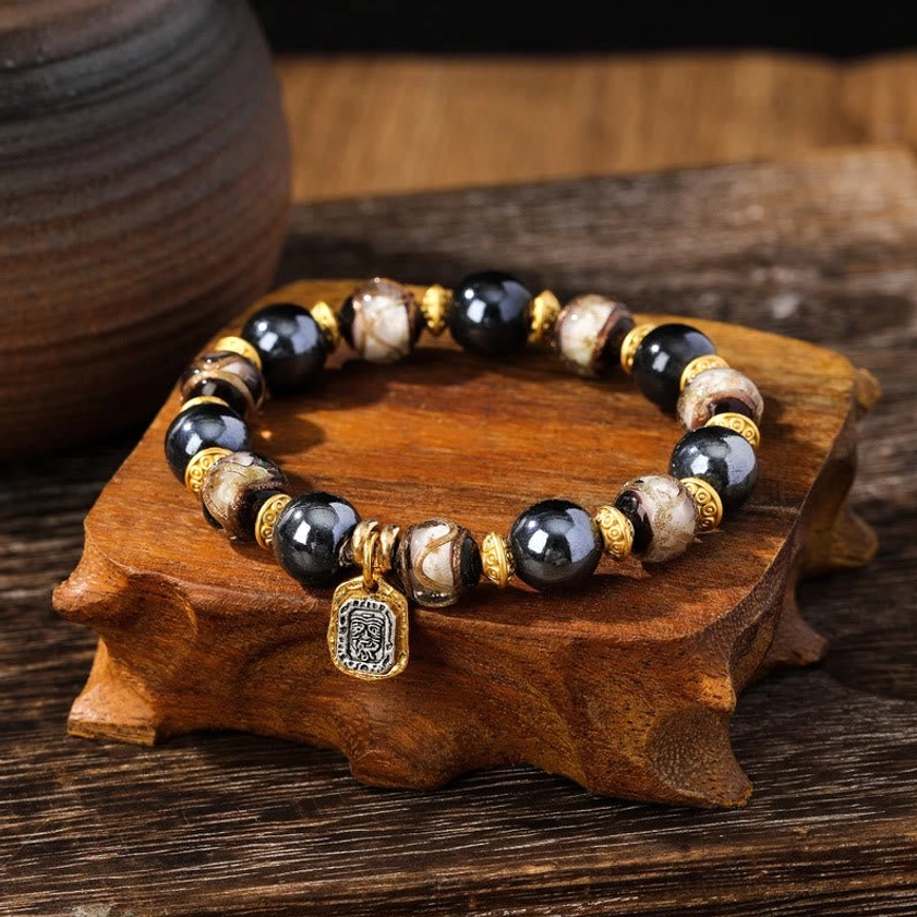 Blue-white Liuli glass Buddhist wealth goddess bracelet with pristine porcelain beads and gold metal accents on wooden display