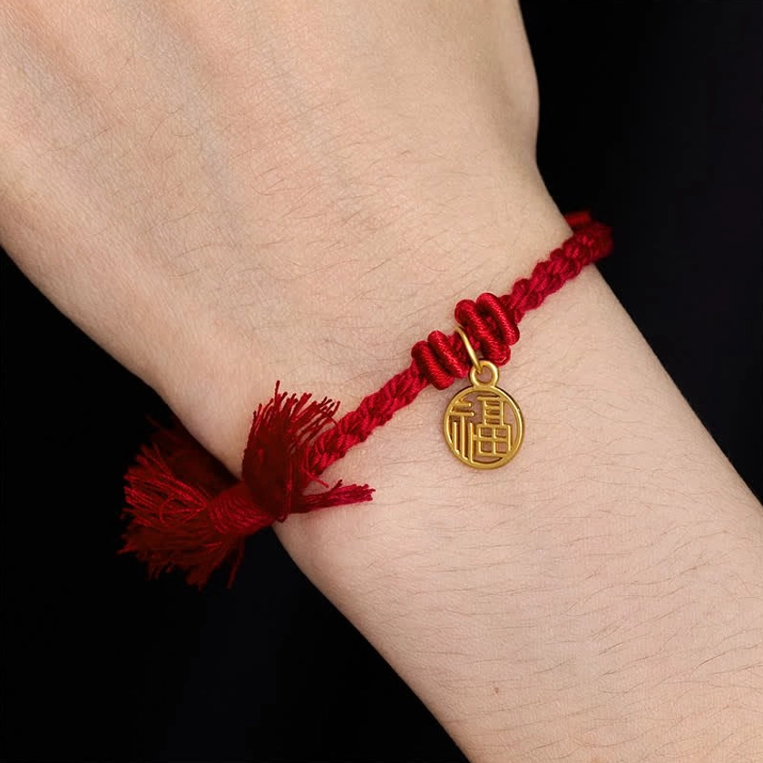 Buddhist red string bracelet close-up showing quality copper charm carving and rope knotting technique