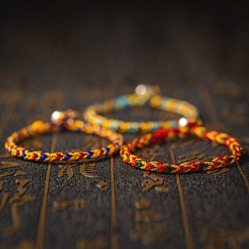Handcrafted multicolored Buddhist protection bracelet detail shot showing premium woven rope weave and authentic 925 silver clasp