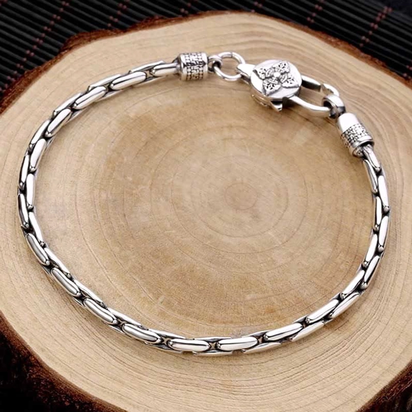 Buddhist spiritual bracelet with double vajra dorje clasp showing secure lobster clasp detail and vintage silver tone finish