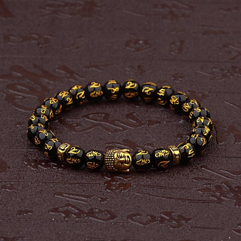 Sacred Six True Words Buddhist bracelet with gold Buddha charm displayed on dark engraved leather background