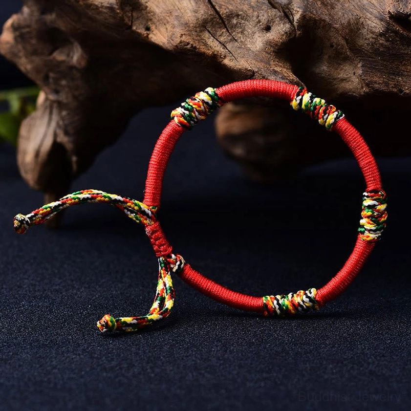 Natural fiber Buddhist protection bracelet with carefully woven colorful knots flat lay display